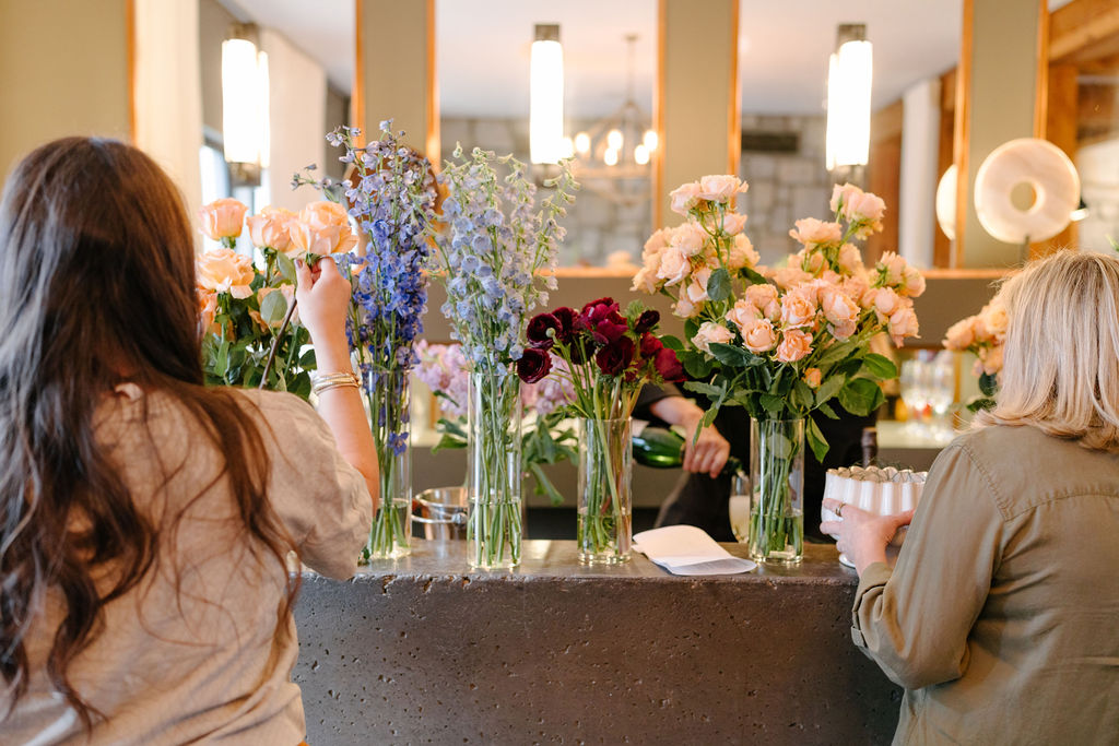Women selecting flowers at retreat bar