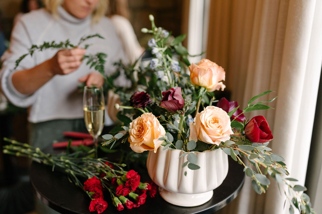 Finished arrangement with peach and red roses